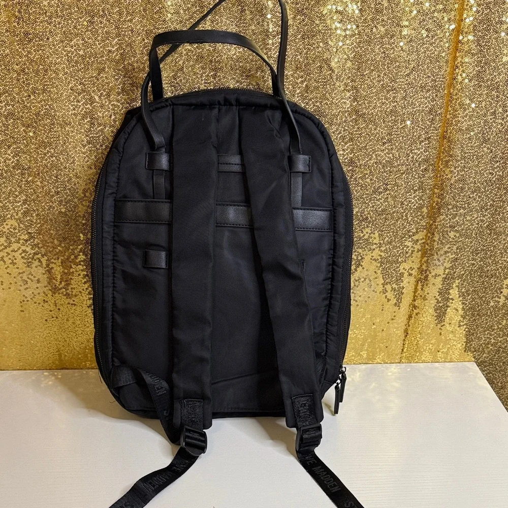 Steve Madden Bjodah Black Quilted Backpack with carry handles and branded strap